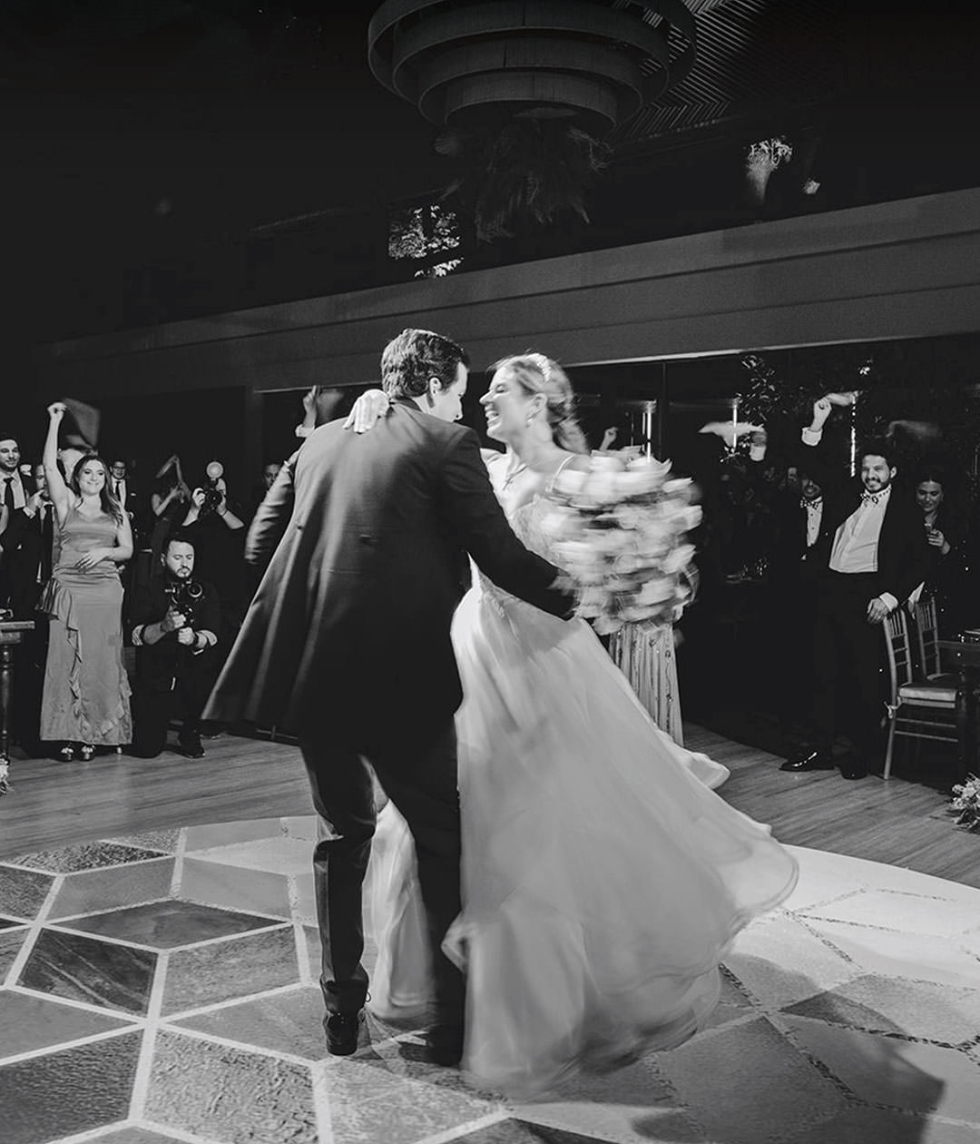 Bride and groom dancing during reception. Documentary photography.