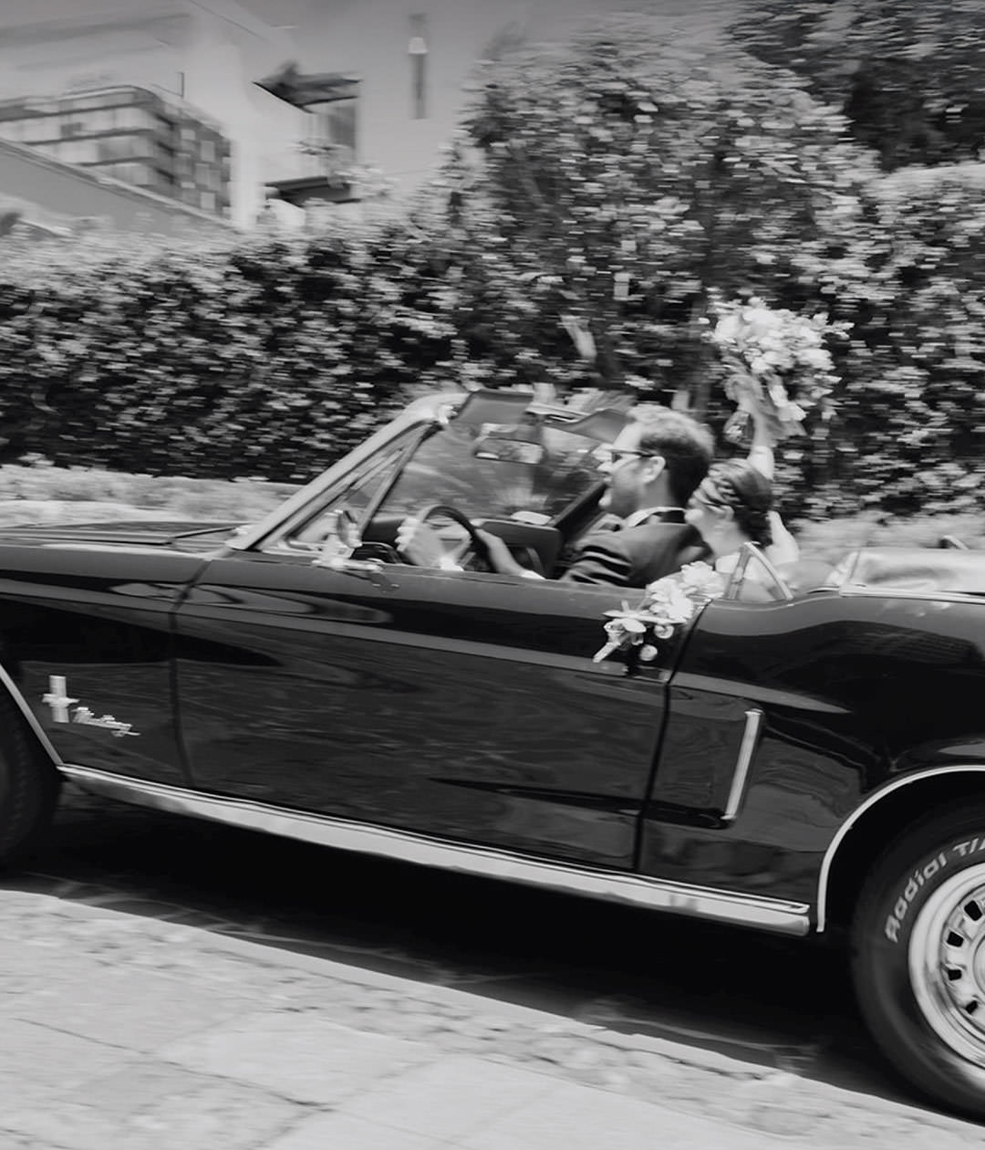 Couple in a vintage car after wedding. Documentary photography.