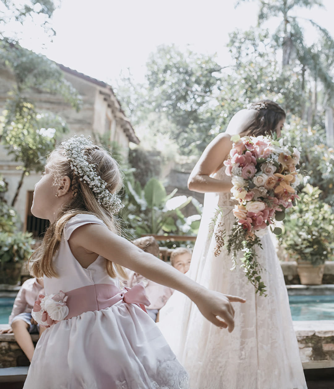 Bride walking near pool with bouquet. Documentary photography.