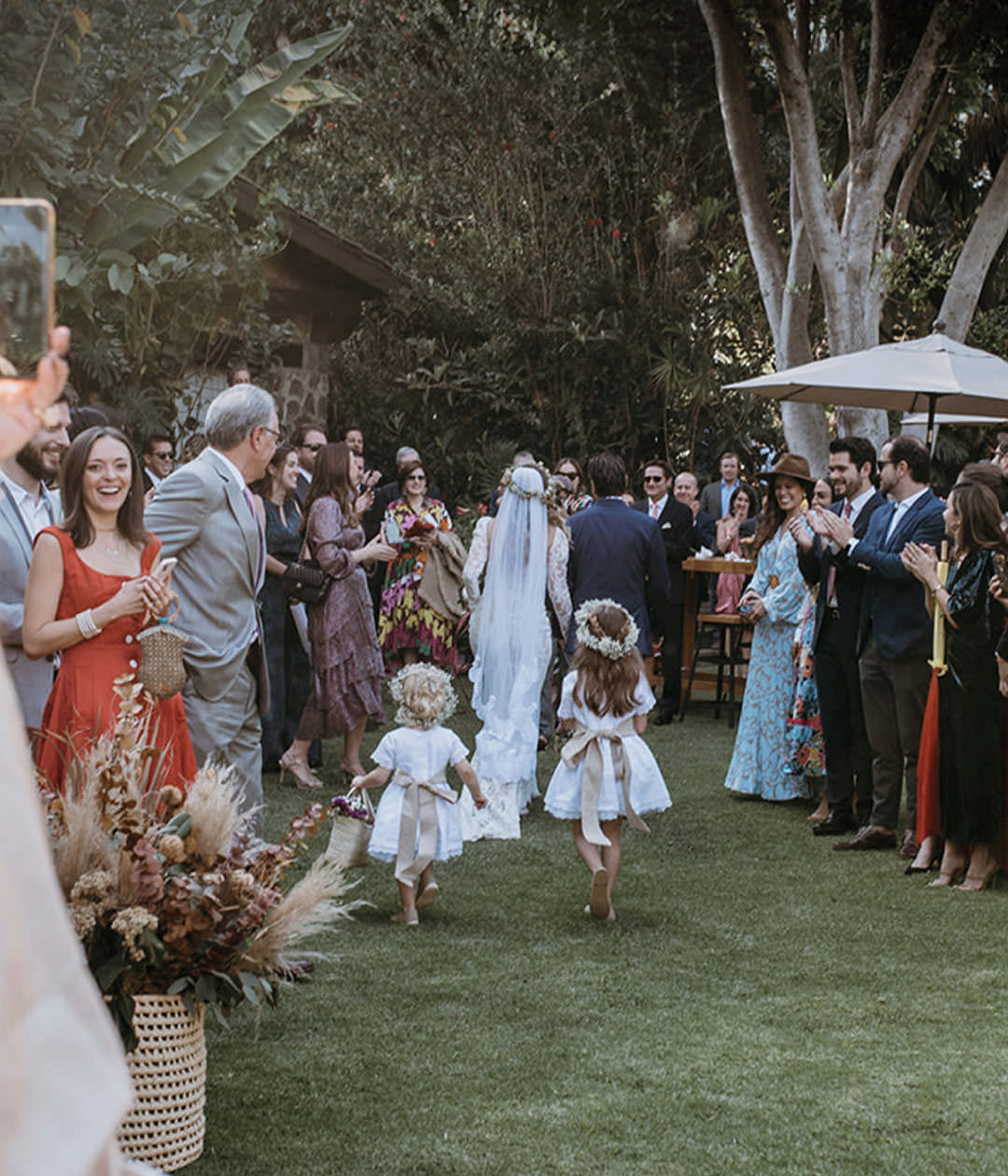 Flower girls leading the bride. Documentary photography.