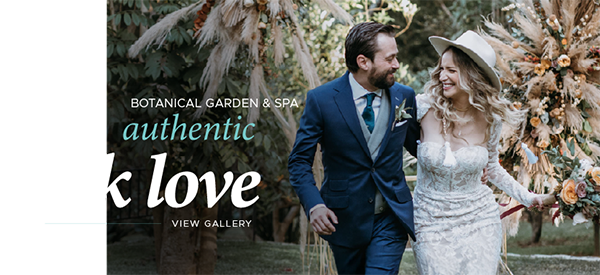 Real Weddings: Smiling bride in hat walking with groom at garden wedding.