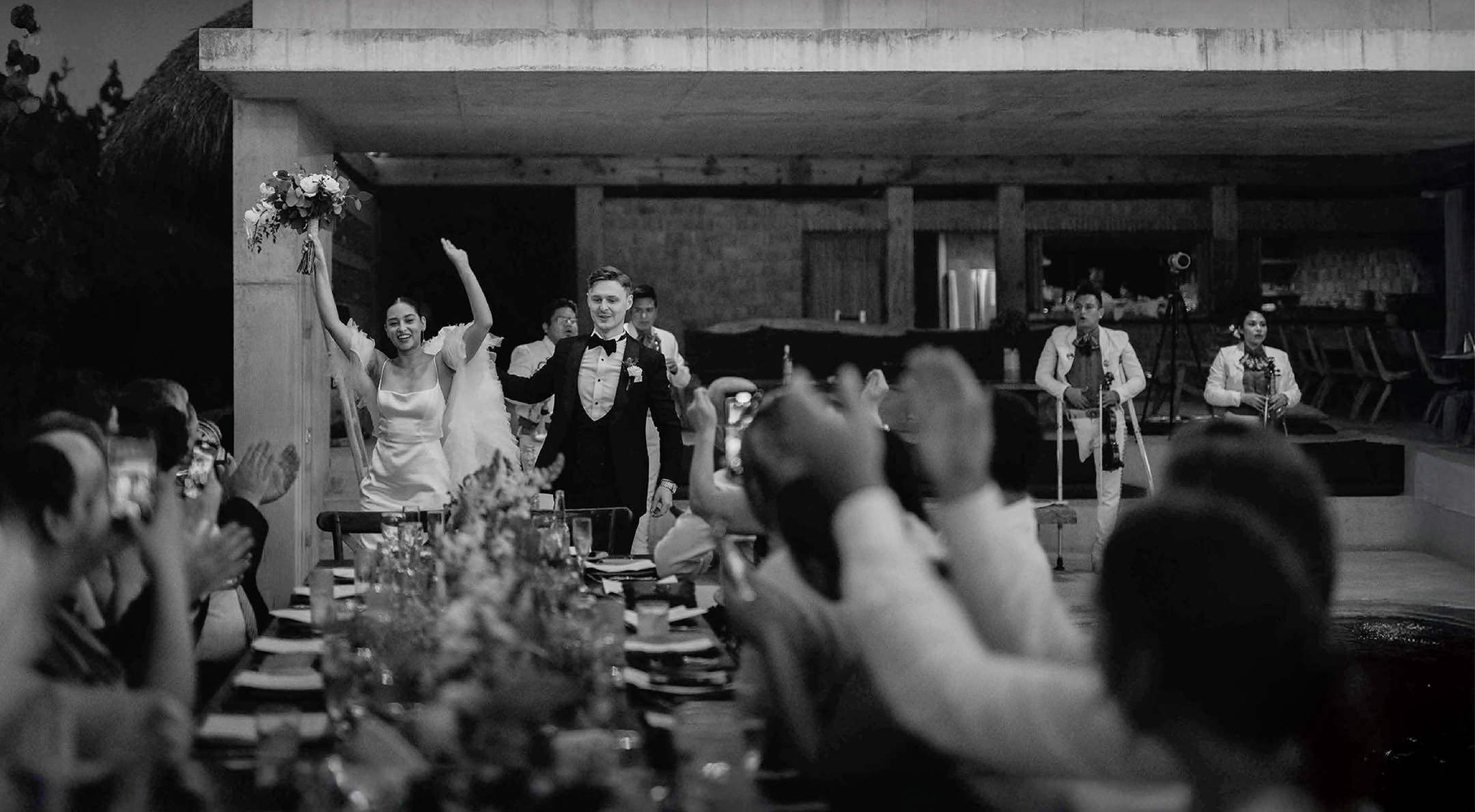 Breathless Weddings Bride and groom entering wedding dinner with mariachi band playing