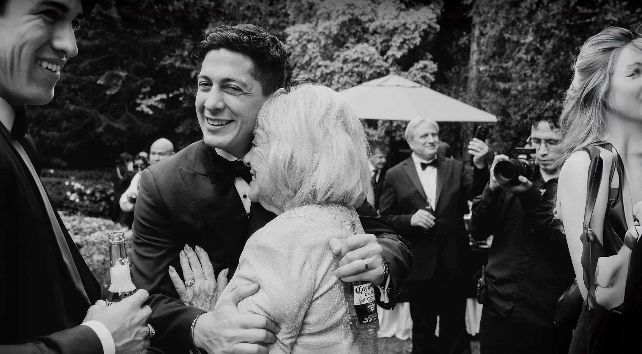 Breathless Weddings Groom hugging his grandmother during wedding celebration.