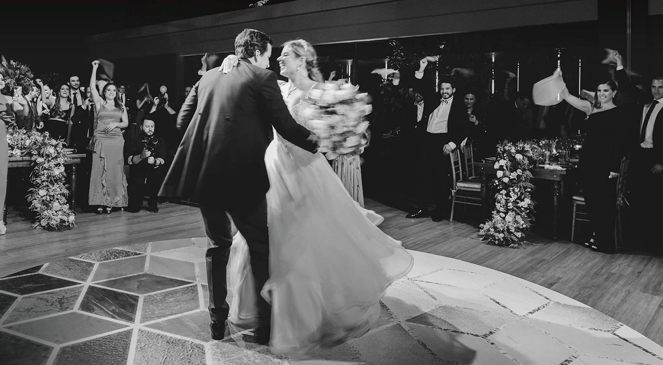 Breathless Weddings Bride and groom dancing as guests cheer during reception.